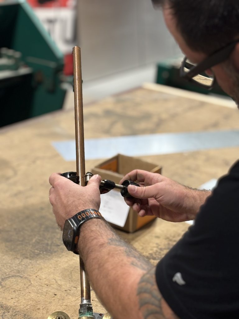 Team Bob's service plumber completing plumbing repair.